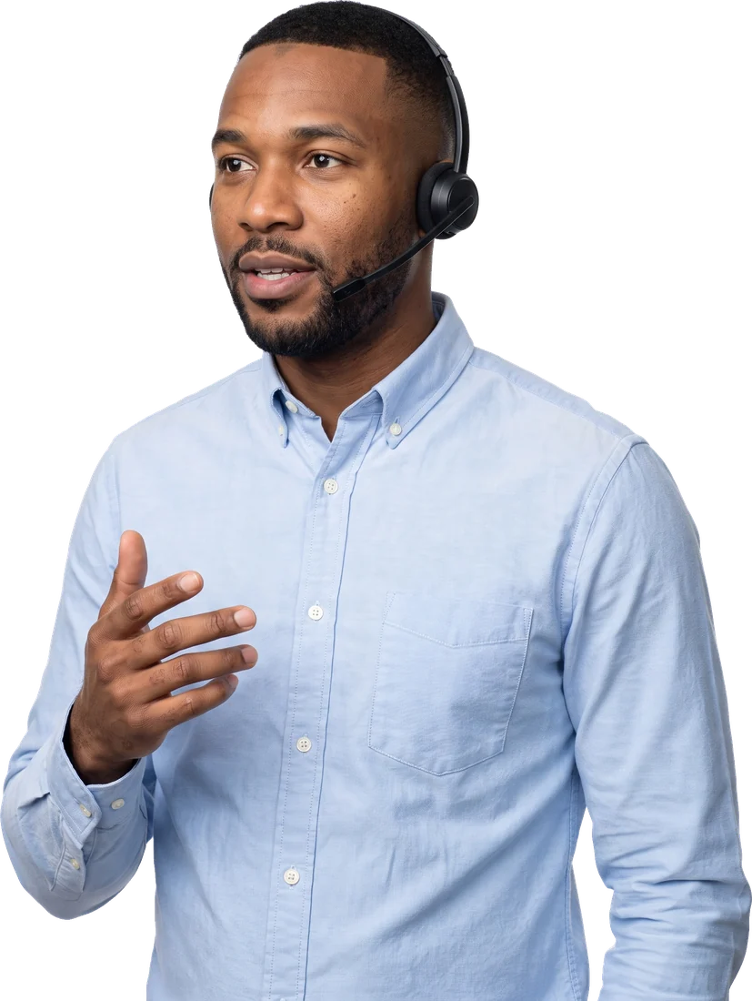 A front-desk clerk on a headset, noting a request